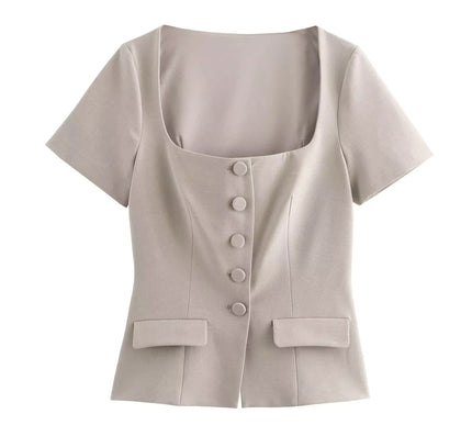 Beige short-sleeve blouse with buttons on a white background